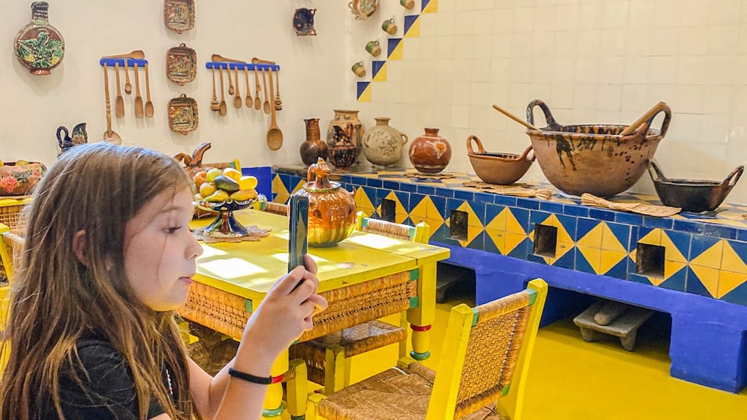 Frida Kahlo Museum kitchen with traditional pottery and utensils on display.