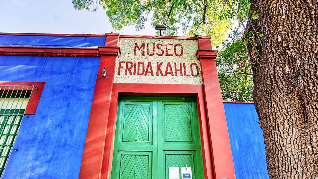 Frida Kahlo Museum entrance with blue walls and green door in Mexico City.