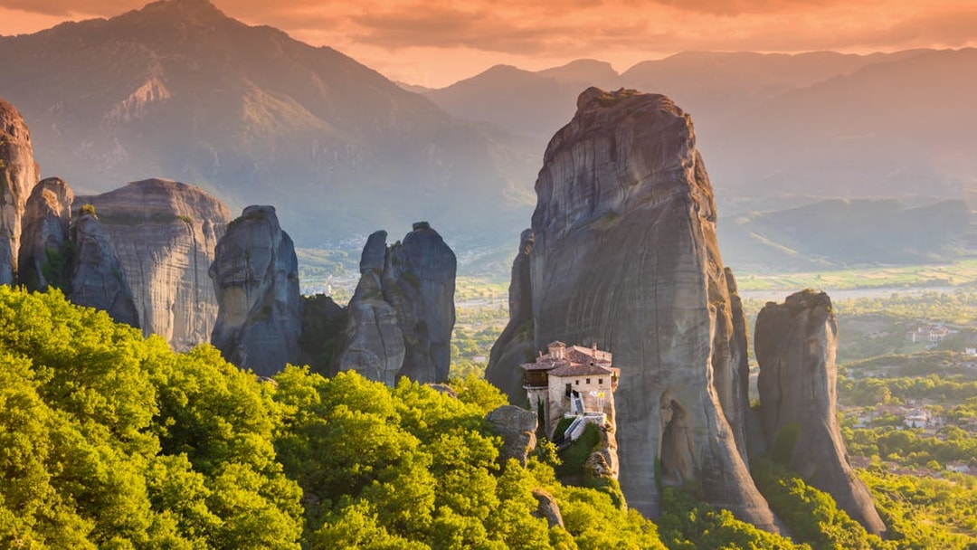 Meteora rock formations with monastery, Greece, viewed during Athens to Meteora full-day trip.