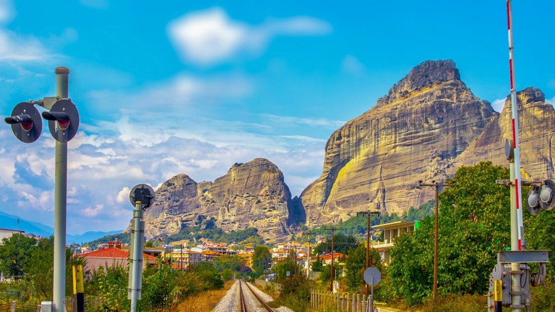 Railway tracks leading to Meteora rock formations in Greece.