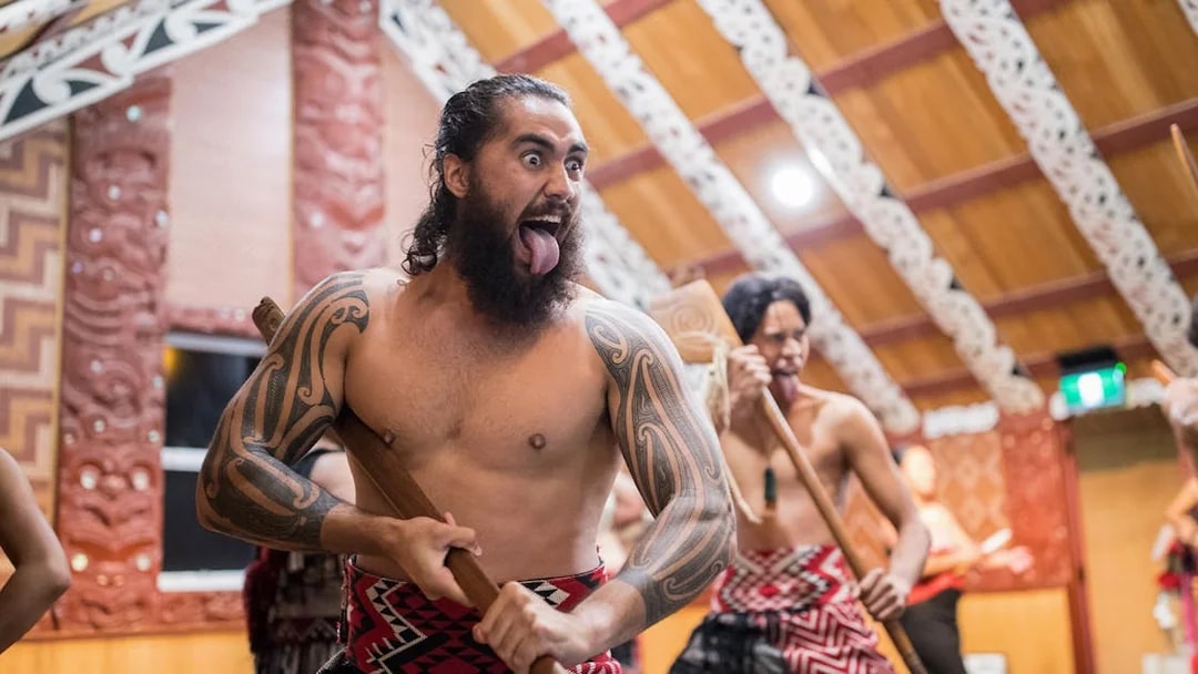 Maori performers in traditional attire during a cultural show in Rotorua, New Zealand.