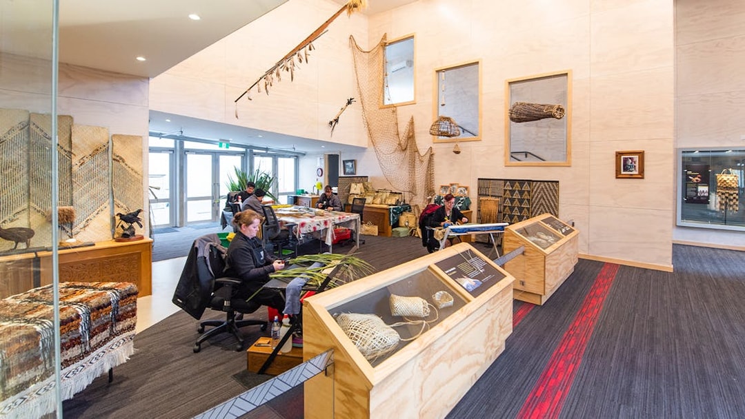Craftsmen weaving flax at Te Puia cultural center, Rotorua, New Zealand.