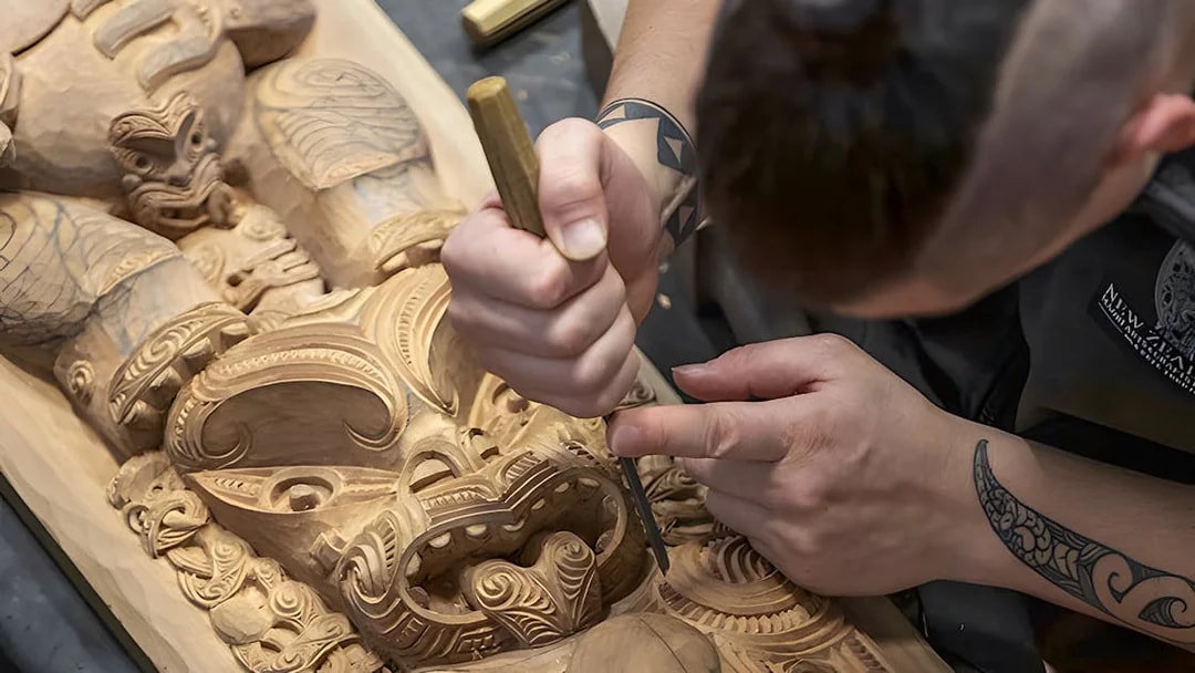 Carving traditional Maori wood sculpture at Te Puia cultural site, Rotorua.