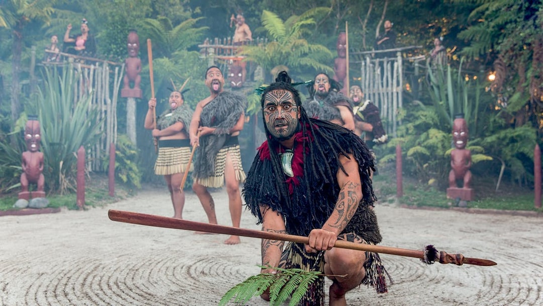 Maori performers in traditional attire during cultural show, Rotorua, New Zealand.