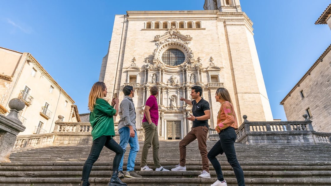 Tourists with guide in front of Girona Cathedral, Spain.