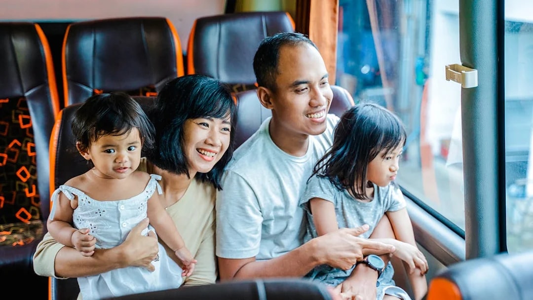 Family enjoying a coach transfer bus ride together.