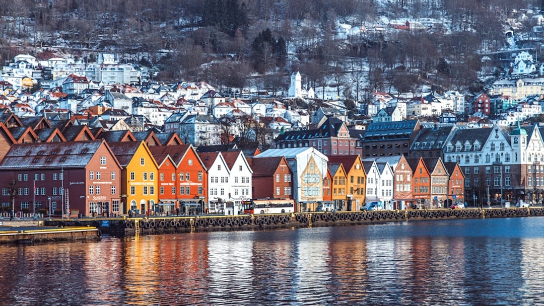 Colorful wooden houses along Bergen's waterfront, Norway, seen from Mostraumen Fjord Cruise.