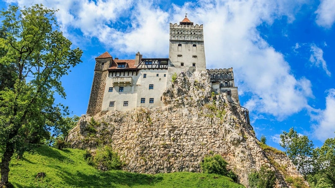 Bran Castle with medieval architecture on a rocky hill in Transylvania, Romania.