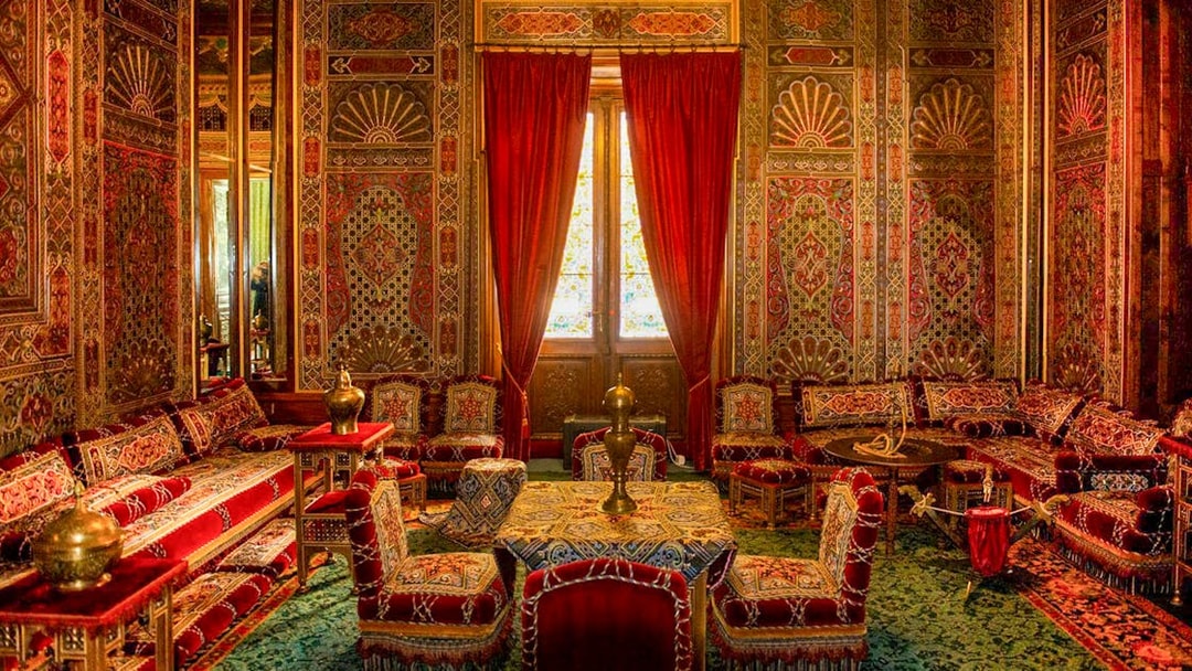 Turkish room with ornate decor and red furnishings inside Peles Castle, Romania.