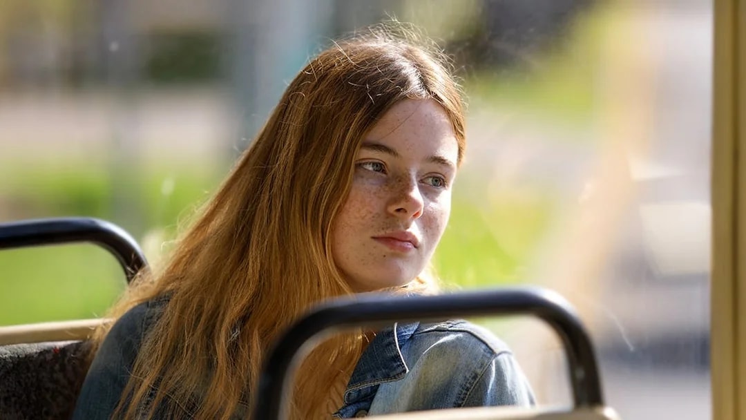 Female guest enjoying scenic views during coach transfer.