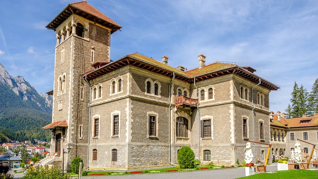 Cantacuzino Castle in Busteni Mountains with scenic backdrop.