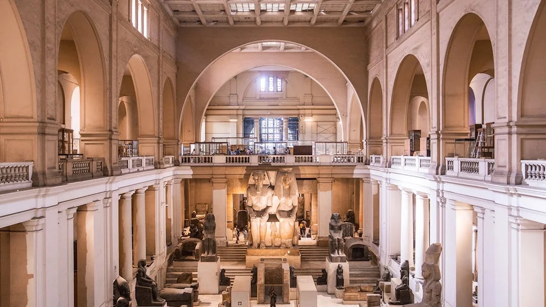 Interior of the Egyptian Museum in Cairo with ancient statues and artifacts.