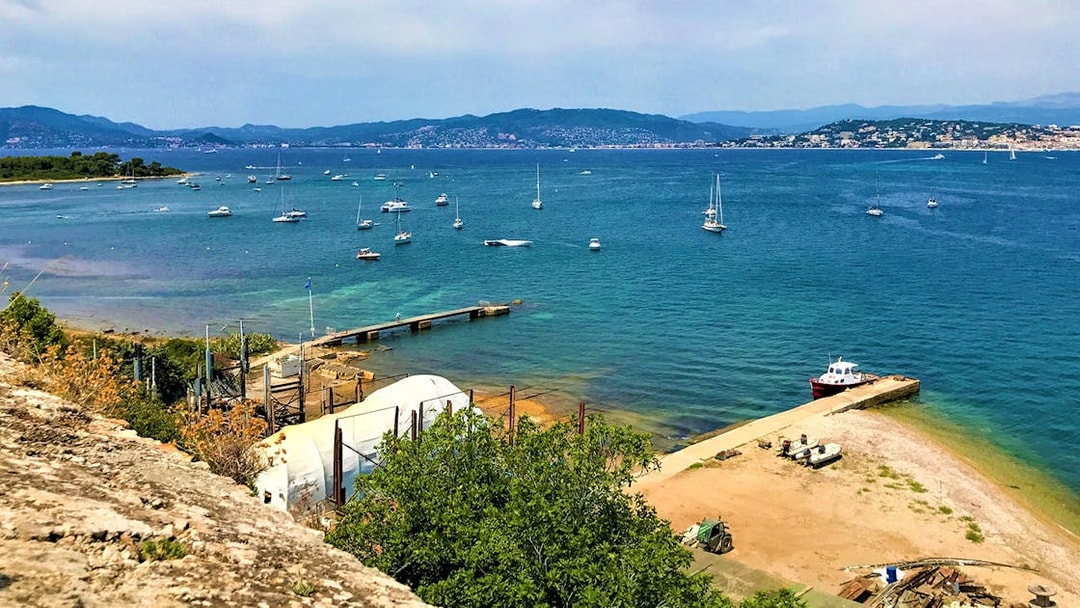 Ferry dock and boats at Ste. Marguerite Island, view from Cannes across the sea.