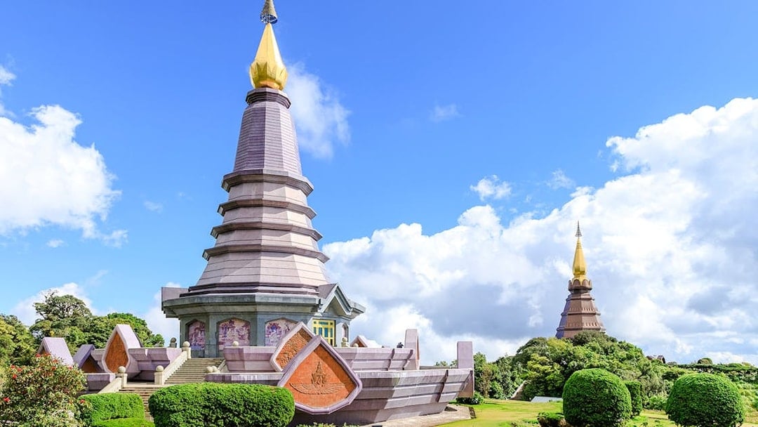 Twin pagodas at Doi Inthanon National Park, Chiang Mai, under a clear blue sky.