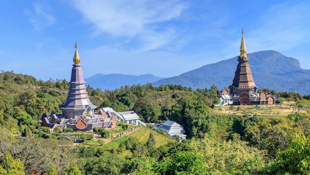 Noppamethanedon and Nopphonphusiri pagodas on Kew Mae Pan trail, Doi Inthanon, surrounded by lush greenery.