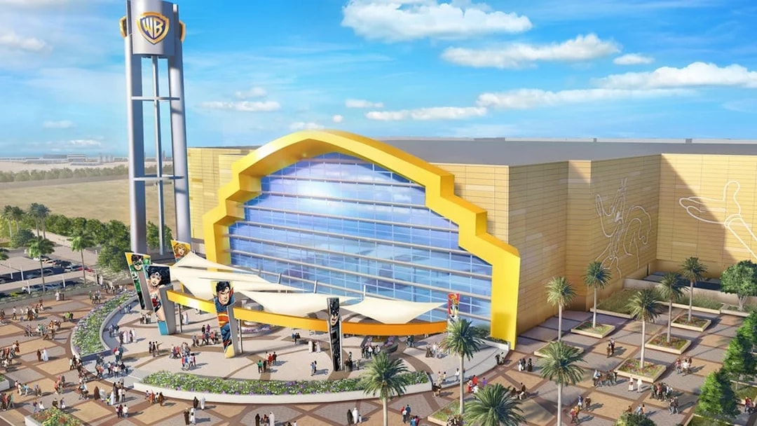 Warner Bros. World entrance on Yas Island, Abu Dhabi with visitors exploring the plaza.