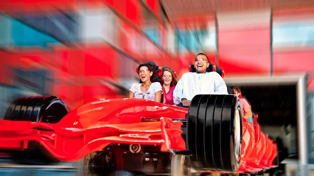 Visitors enjoying a high-speed roller coaster ride at Ferrari World Abu Dhabi.