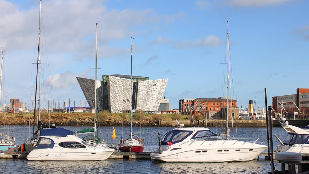 Titanic Belfast Museum with boats docked in the foreground, United Kingdom.