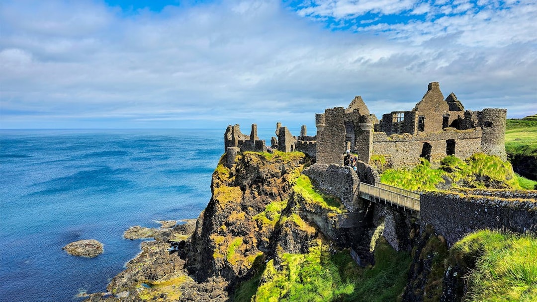 Dunluce Castle ruins on a cliff overlooking the North Atlantic Ocean in Northern Ireland.