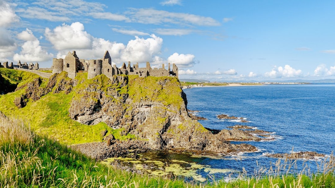 Dunluce Castle ruins on a cliff overlooking the North Atlantic Ocean in Northern Ireland.