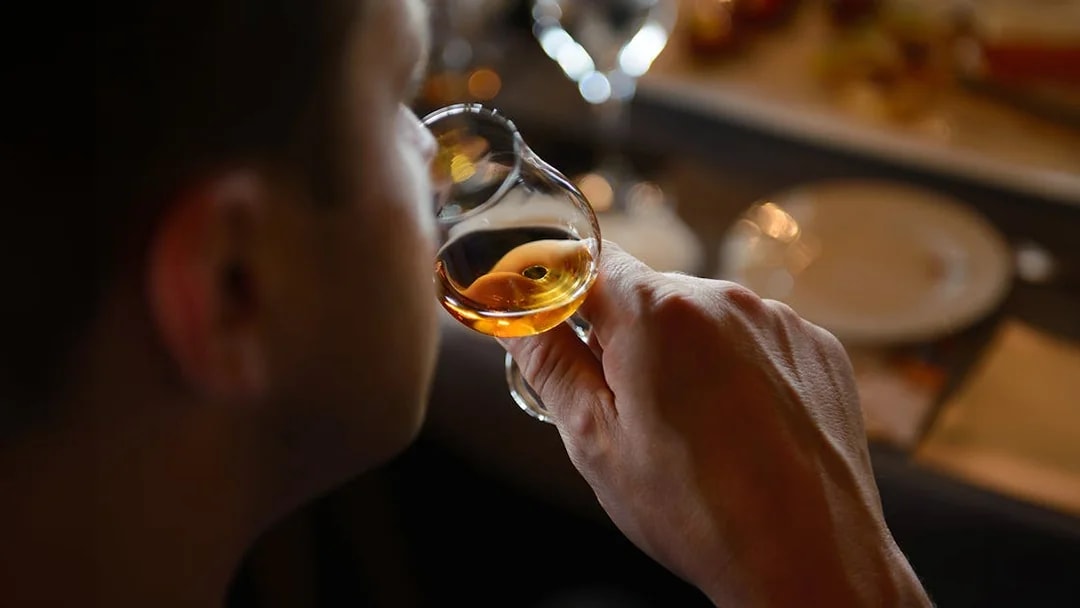 Guest sampling whiskey during Edinburgh Whiskey Tasting Tour.