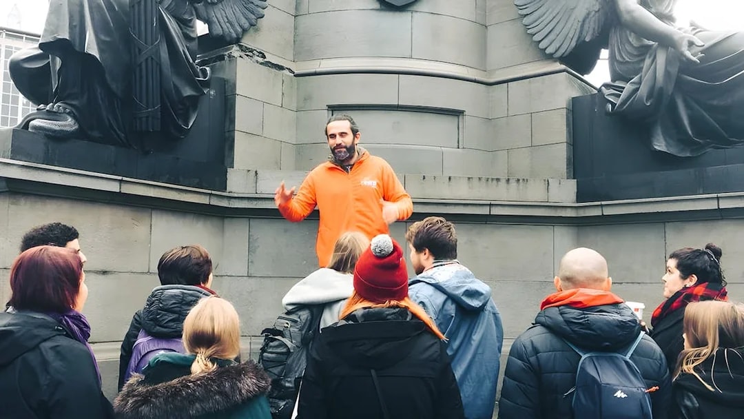 Tour guide leading a group at a monument in Dublin.