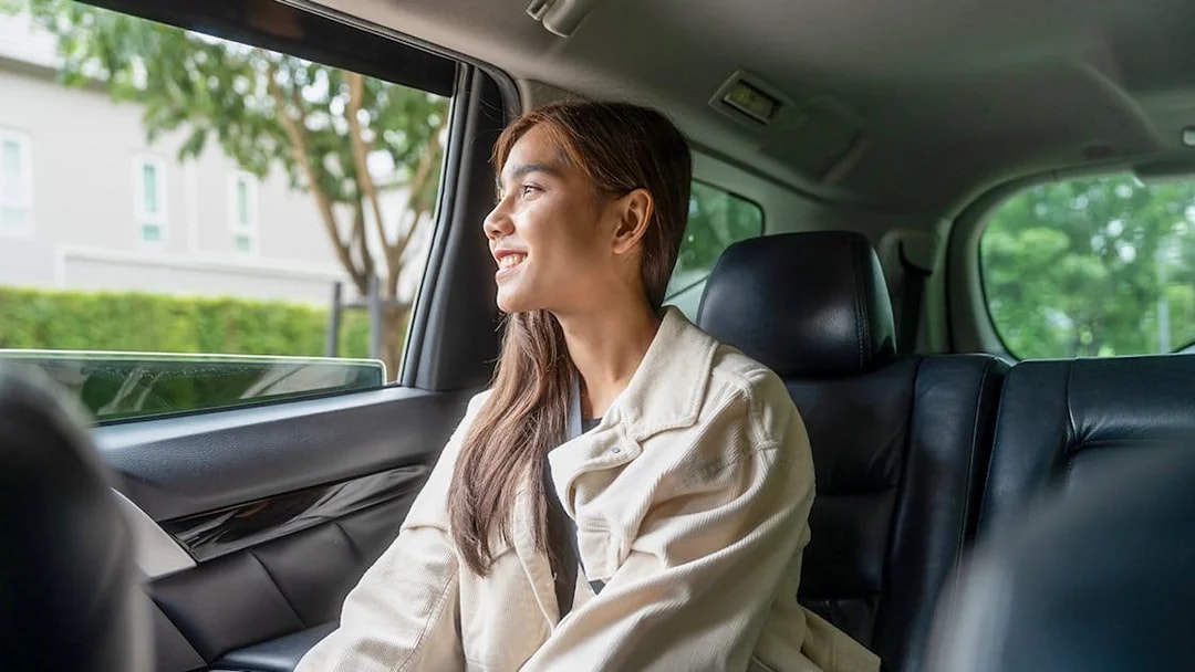 Female guest enjoying car transfer from Tirana, looking out the window.