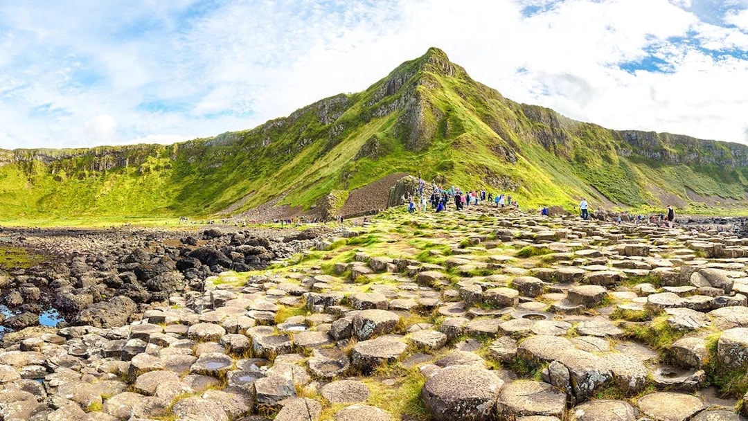 Visitors exploring the basalt columns at Giant's Causeway, Northern Ireland.