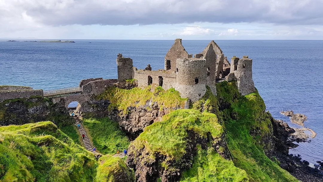 Dunluce Castle ruins on a cliff overlooking the sea in Northern Ireland.