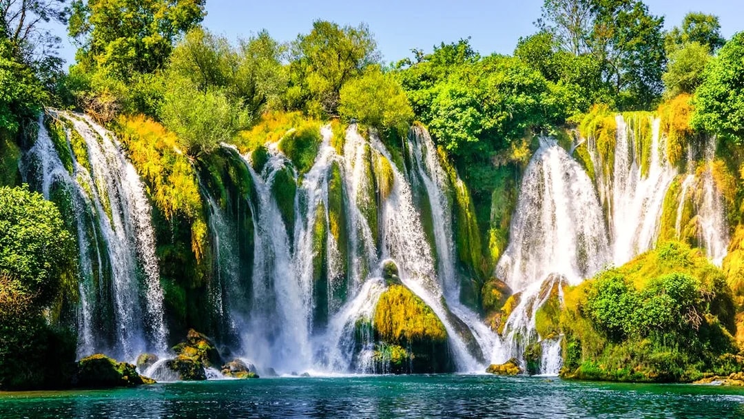 Kravica Waterfall cascading over lush greenery on Trebizat River, Bosnia.