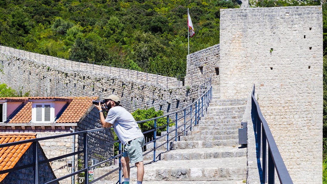 Visitor photographing Ston walls in Croatia.