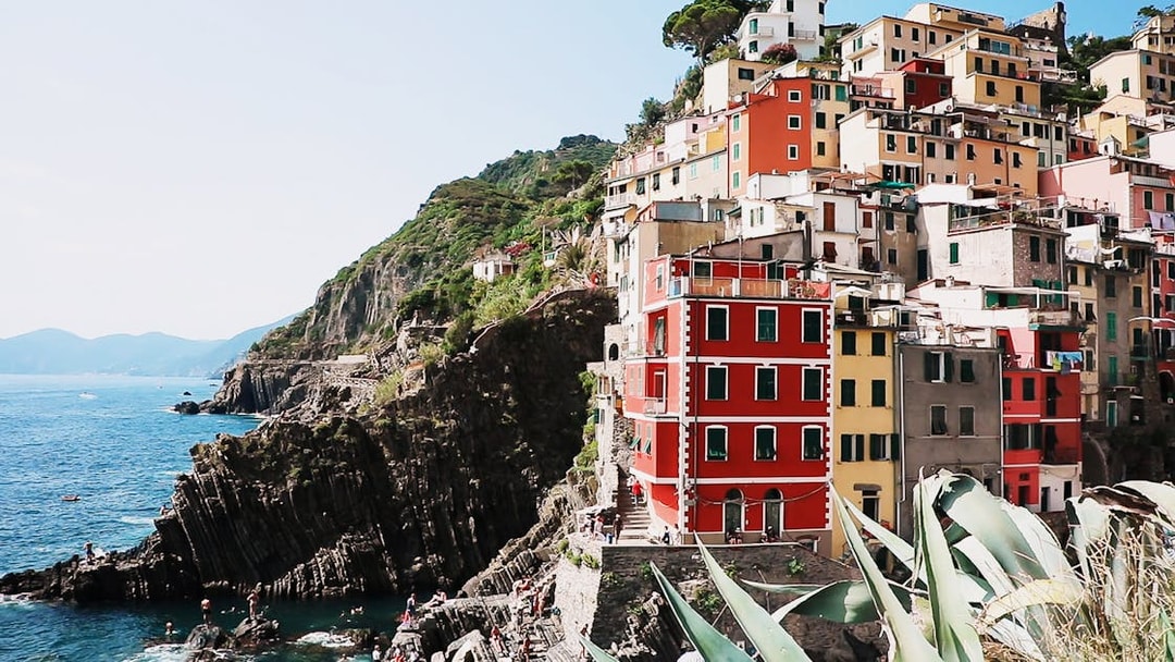 Colorful cliffside buildings in Riomaggiore, Cinque Terre, overlooking the sea.