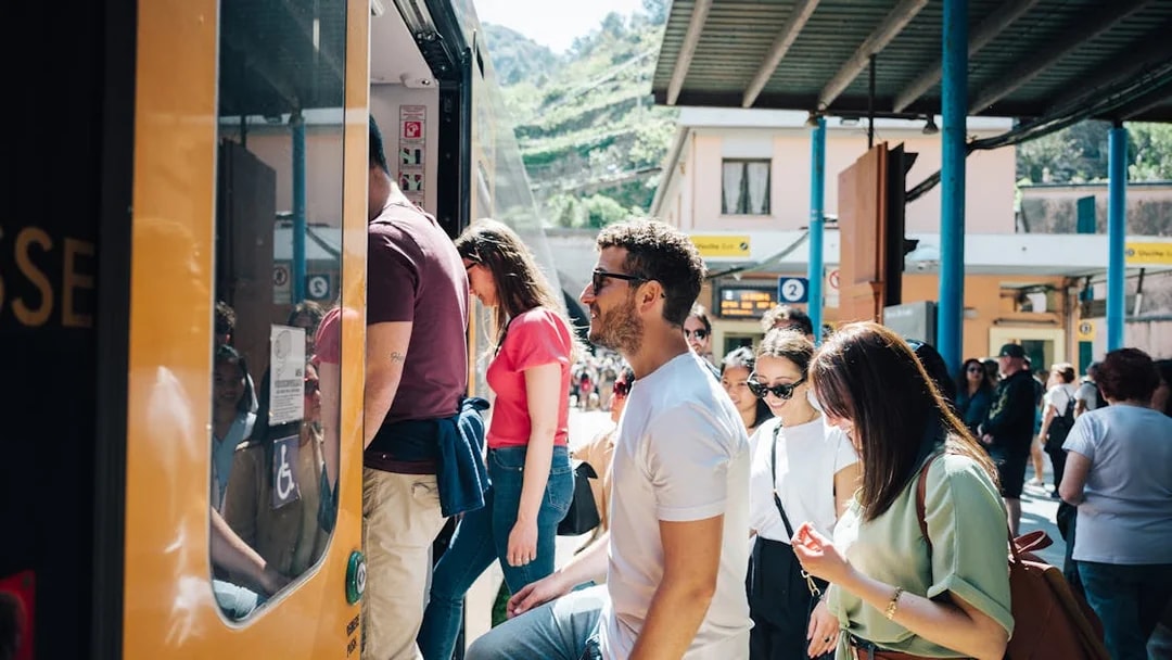 Tourists boarding a train at a Cinque Terre station, Italy.