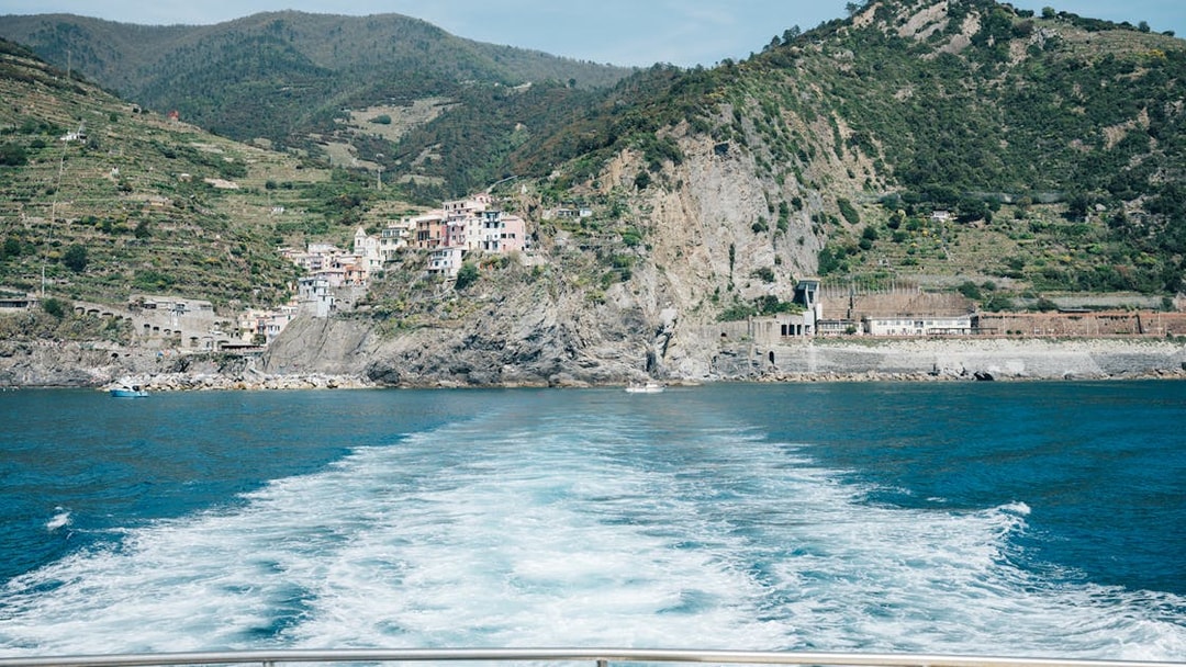 Cinque Terre coastline view with colorful hillside village and sea.