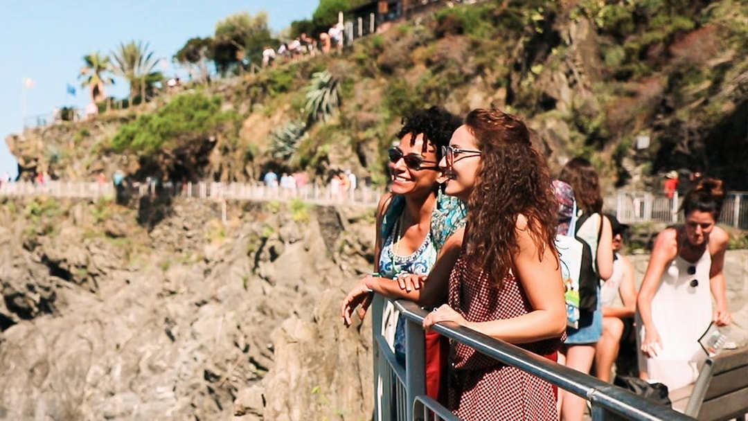 Visitors enjoying the scenic view of Cinque Terre cliffs on a guided tour from Florence.