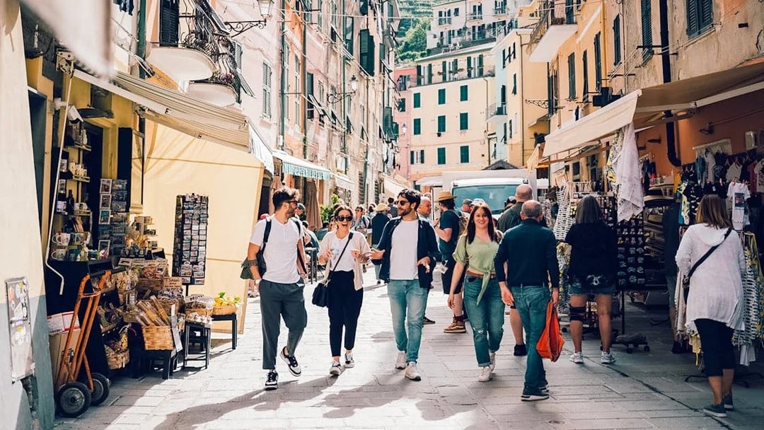 Participants exploring a vibrant street in Cinque Terre during a day trip from Florence.