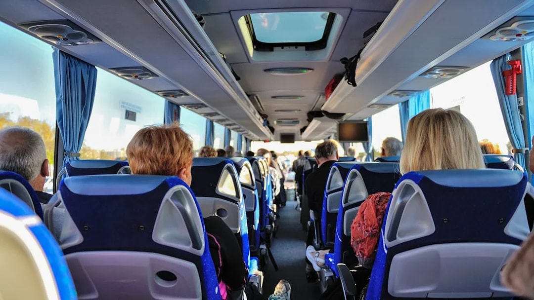 Tourists seated inside a bus on the Florence to Cinque Terre guided tour.
