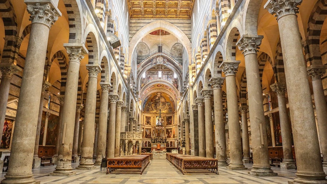 Interior of Pisa Cathedral with ornate columns and arches, part of a guided tour from Florence.