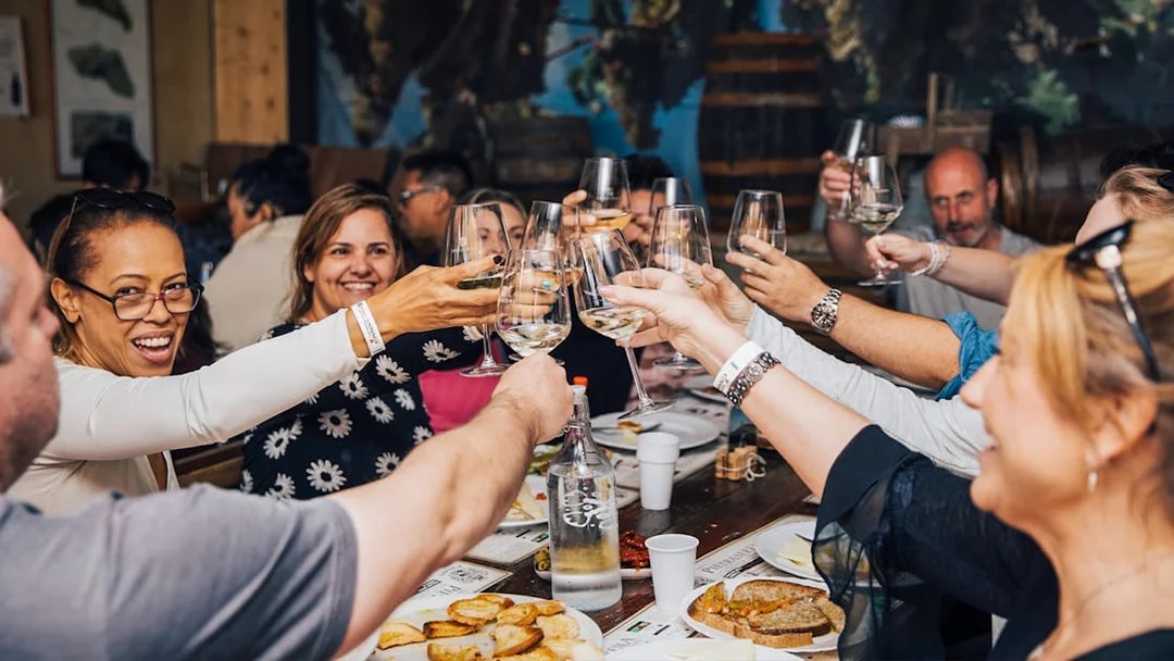 Group enjoying wine tasting in Tuscany during Siena, San Gimignano, and Pisa tour.
