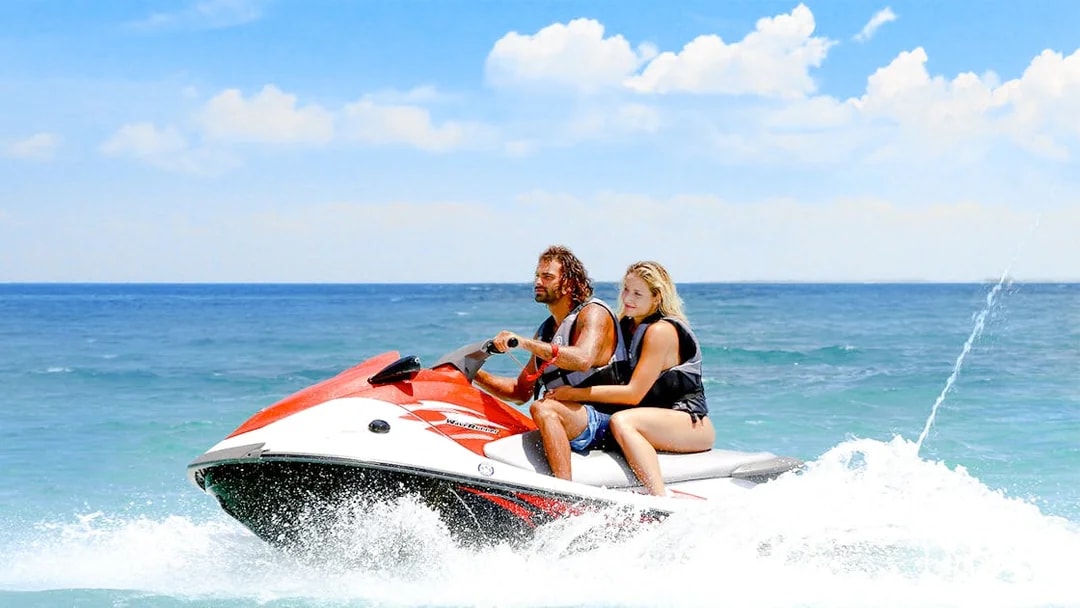 Guests jet skiing on clear waters in Bimini.
