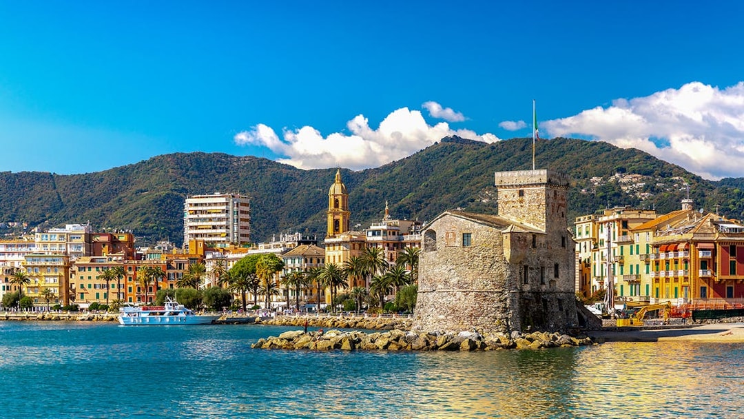 Rapallo seaside with historic castle and colorful buildings, day trip from Genoa to Portofino.