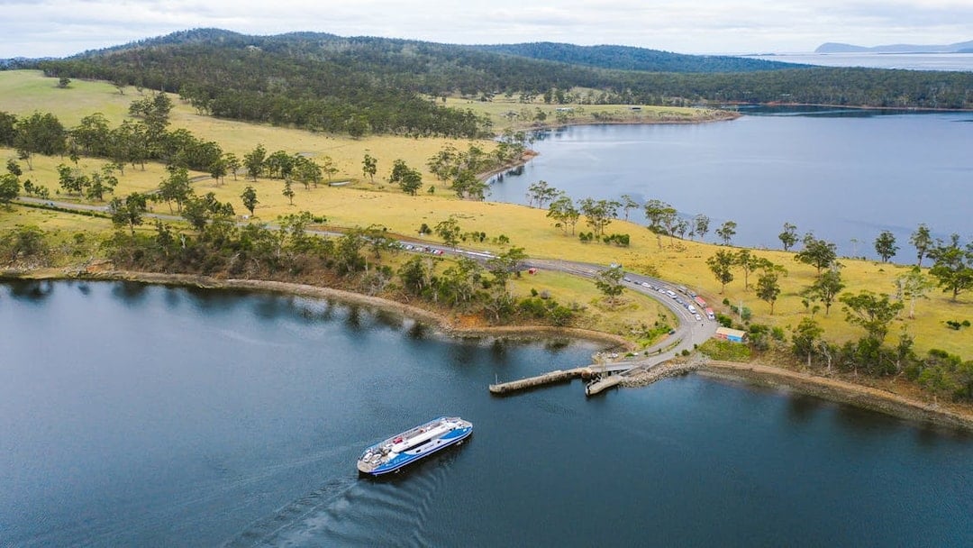Bruny Island coastline with ferry approaching dock, part of Hobart full-day guided tour.