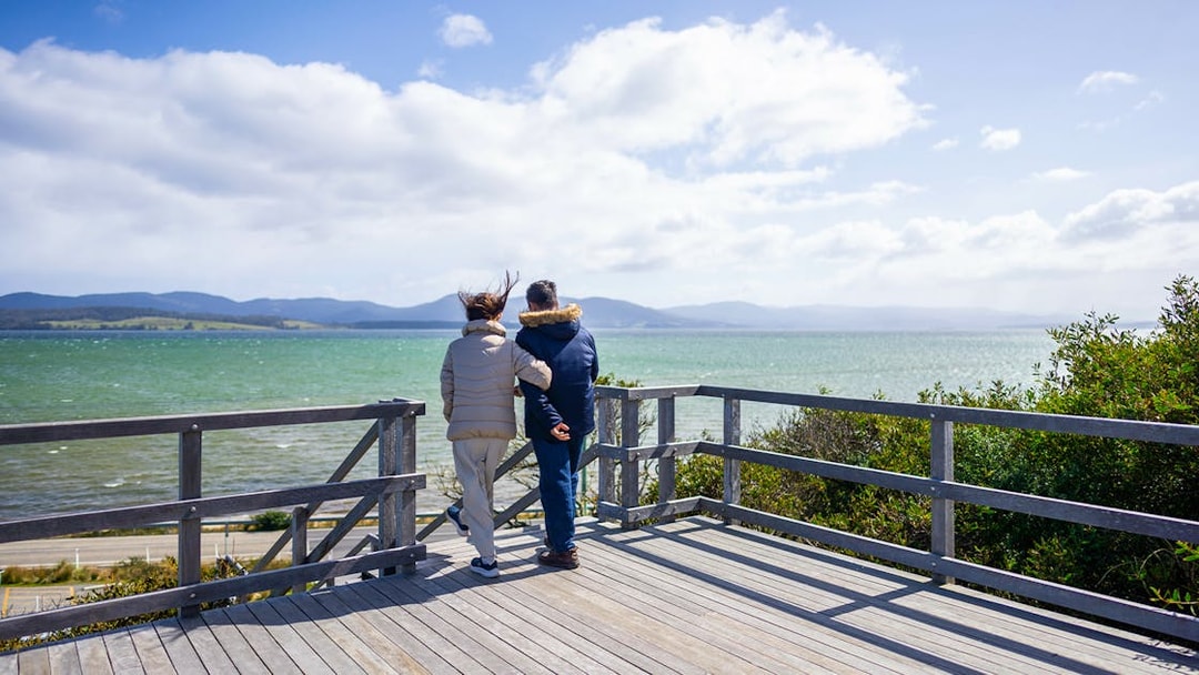 Couple enjoying Bruny Island coastline view, part of Hobart full-day guided tour.