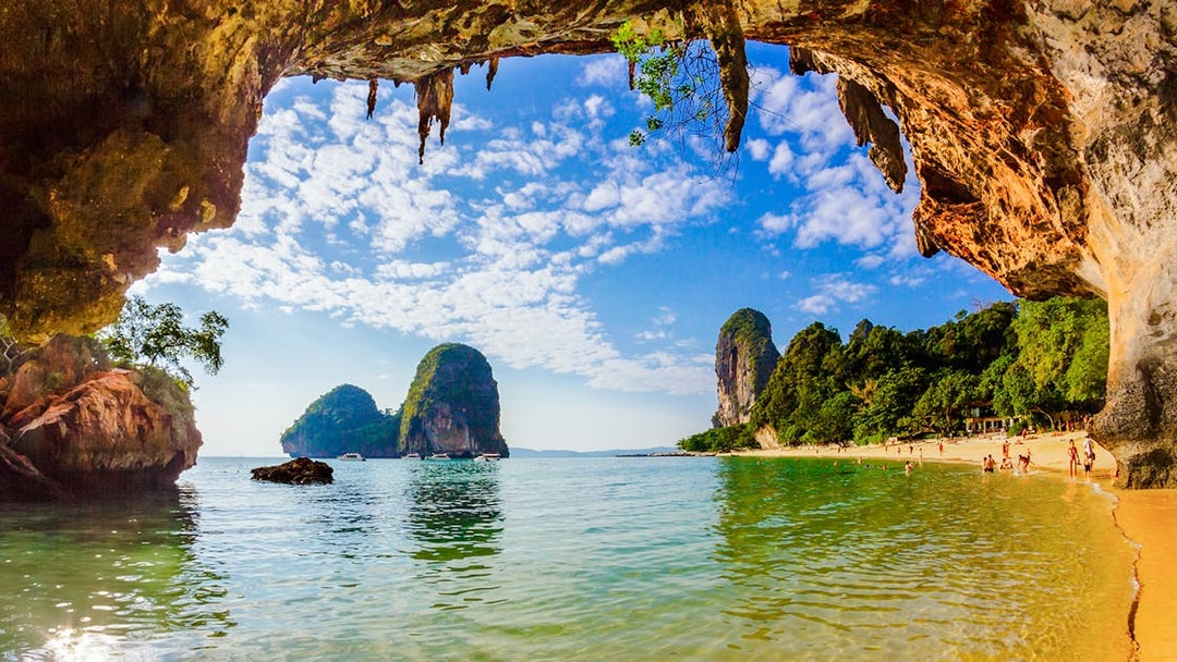 Phra Nang Cave Beach in Krabi with limestone cliffs and clear water.