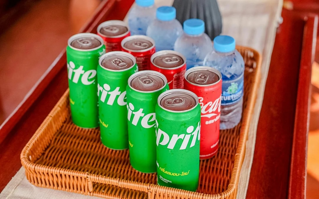Soft drinks and water bottles in a basket on a tour boat.