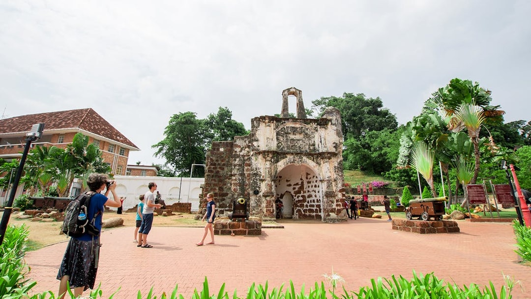 A Famosa fortress ruins with tourists exploring in Melaka, Malaysia.