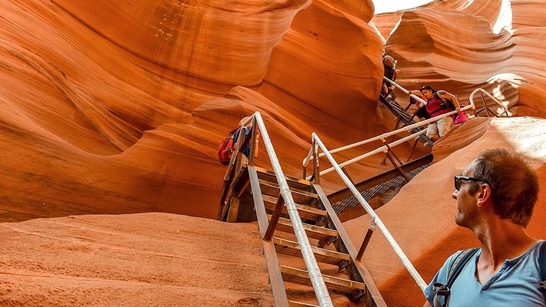 Tourists climbing stairs in Lower Antelope Canyon, Arizona, during a day tour from Las Vegas.