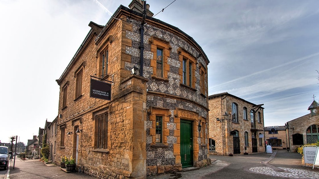 Cotswolds village street with historic stone buildings on a guided day tour from London.