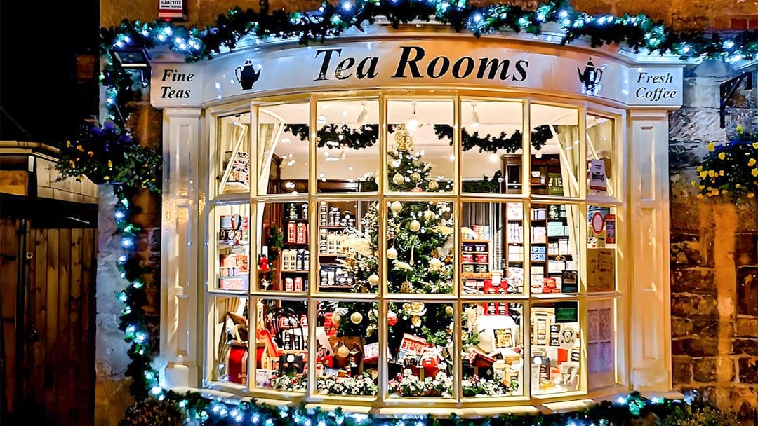Cotswolds tea room window with festive decorations and tea products on display.