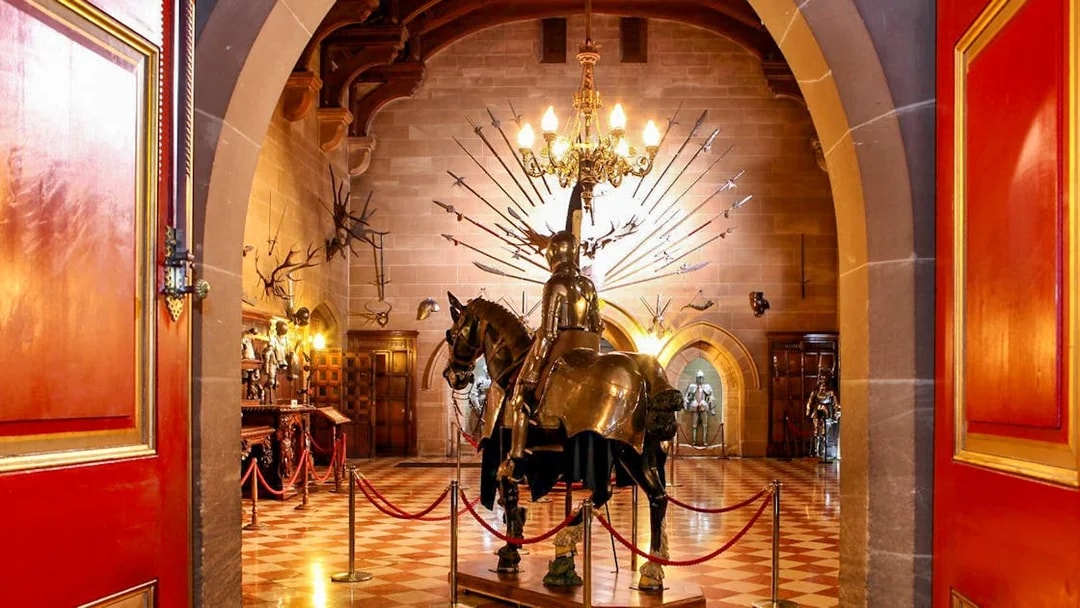 Warwick Castle interior with knight armor display and medieval decor.
